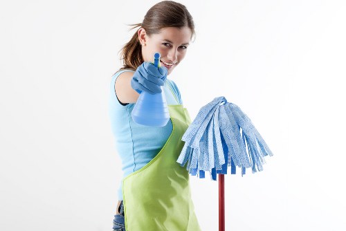 Professional cleaner organizing a spotless living room in housecleaningservices