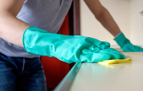Cleaner disinfecting bathroom surfaces in a residential house